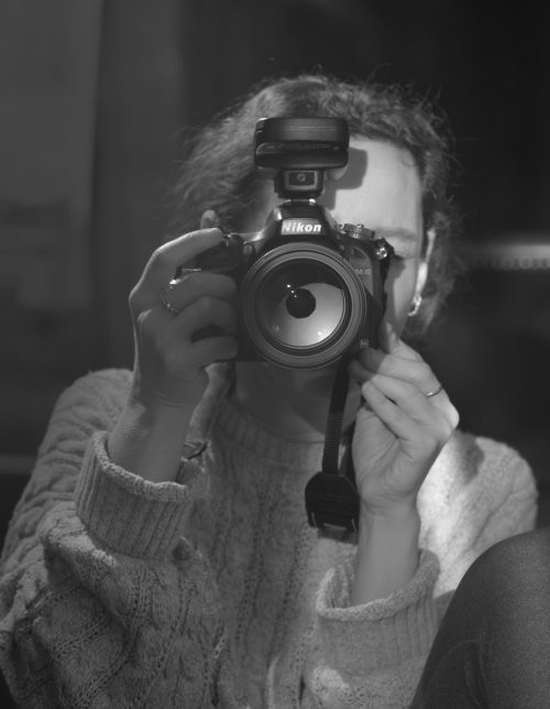 austin portrait photographer tanya eivin holding a camera pointed at the viewer