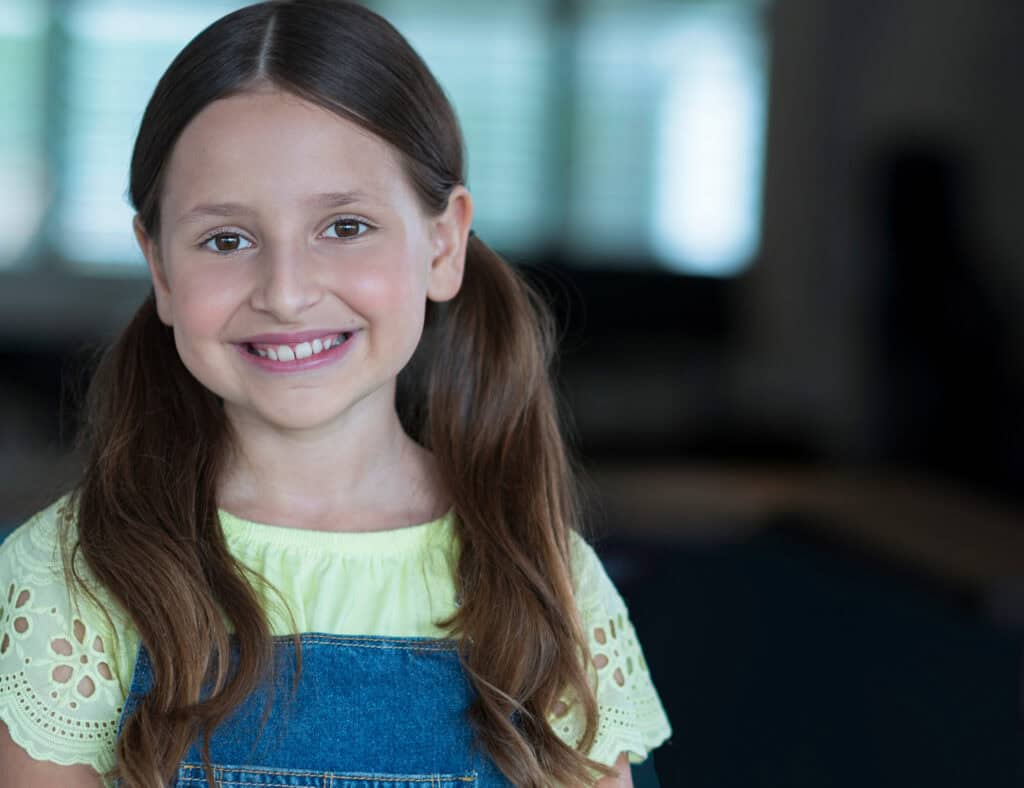 actor headshots of a child smiling at the camera