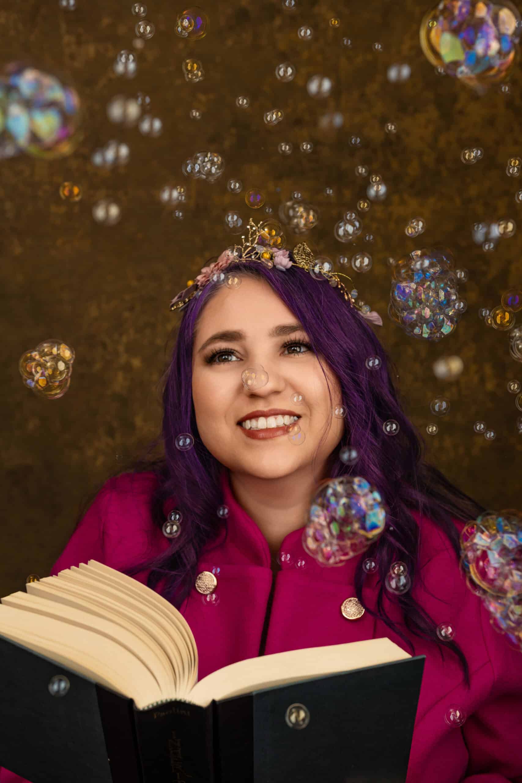 A woman reading a book with bubbles around her photographed by Tanya Eivin Photography