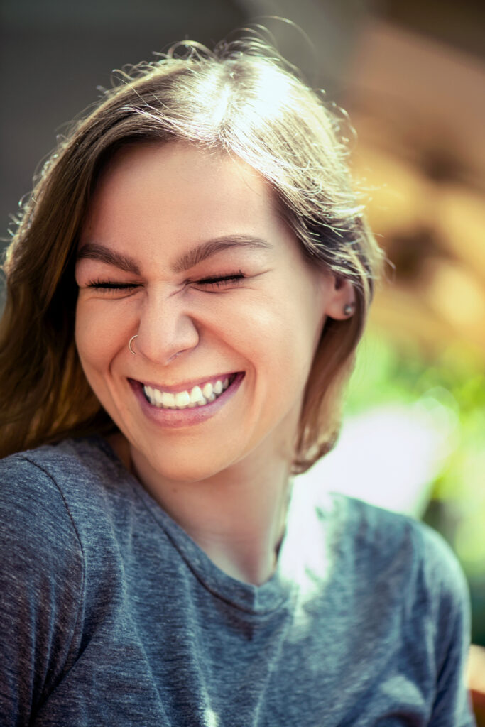 a close up senior portrait of a girl laughing in austin tx