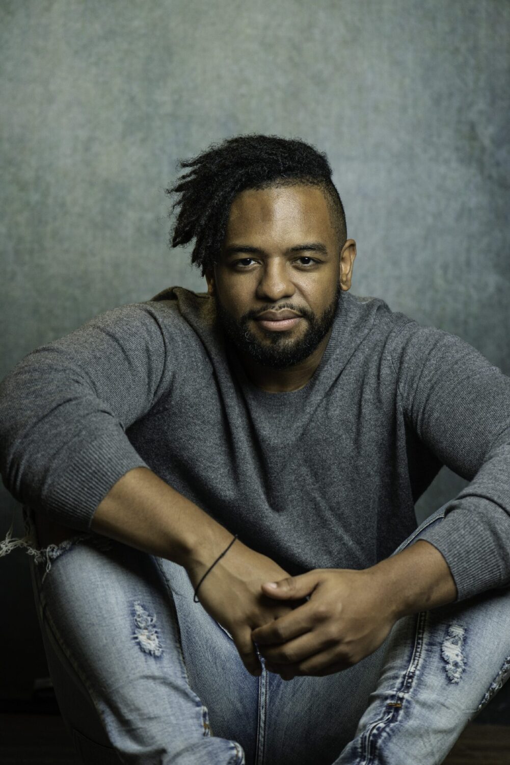 Young men's dating profile image example. Young man in a grey sweater and light jeans. Image by Tanya Eivin Photography in Austin, Texas.